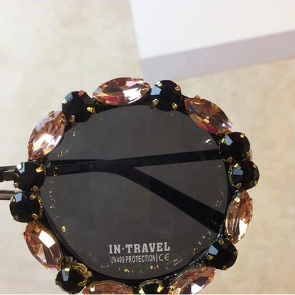 Sunglasses with decorative frame on a light background