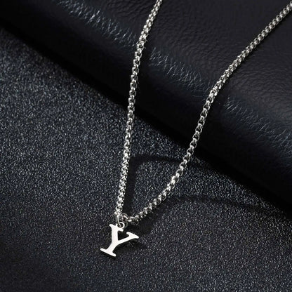 Silver necklace with a 'Y' pendant on a black textured surface