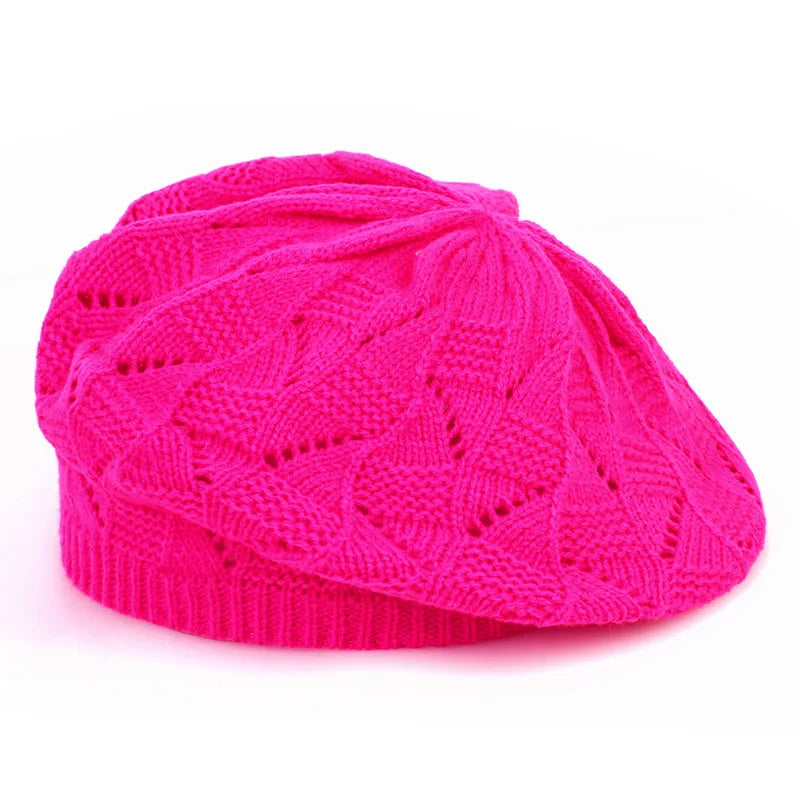 Pink knitted beret on a white background