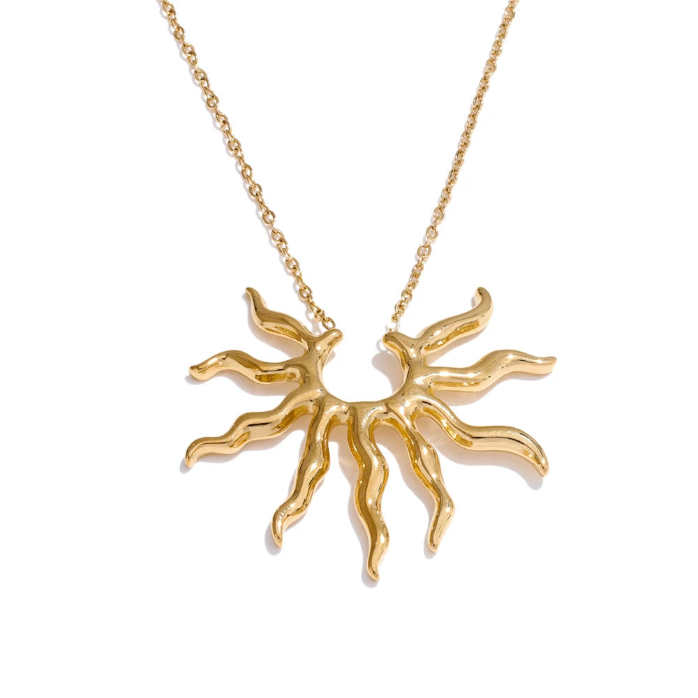Gold sun-shaped pendant necklace on a white background