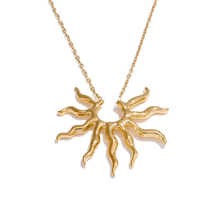 Gold sun-shaped pendant necklace on a white background