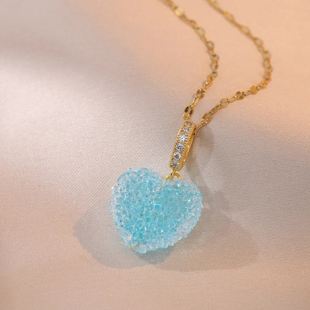 Necklace with a blue heart-shaped pendant on a soft pink background