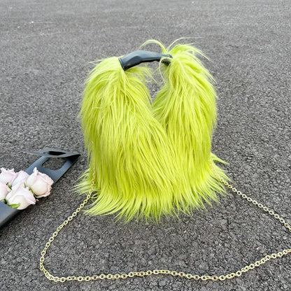 Neon green furry handbag with a chain strap on a dark surface