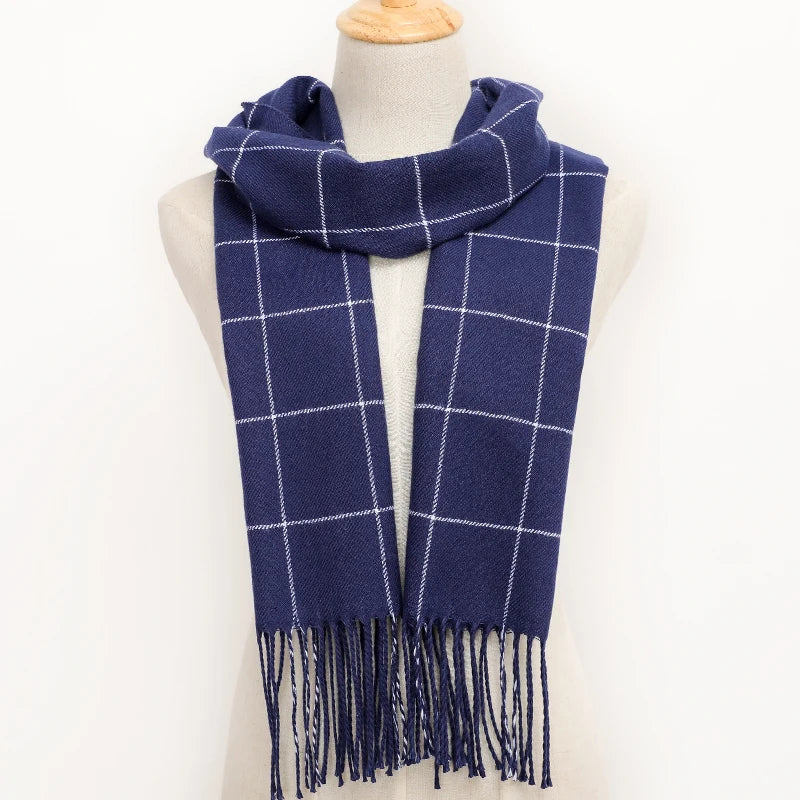 Navy blue plaid scarf with fringes on a mannequin against a white background