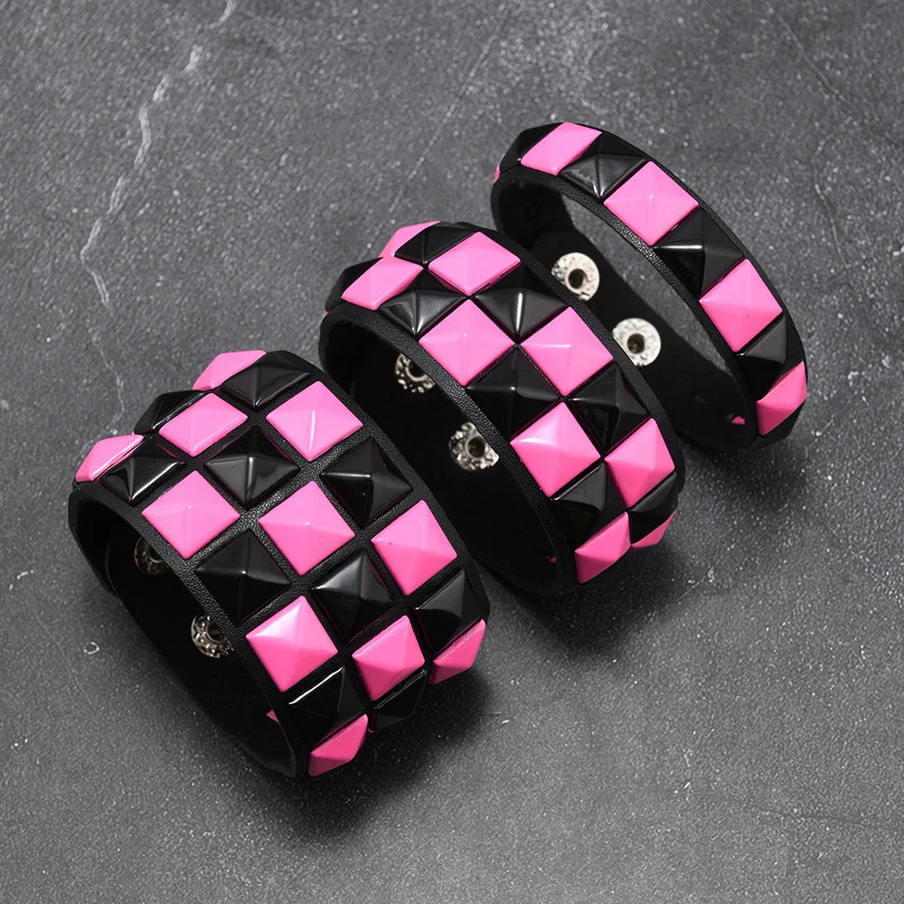 Black and pink checkered bracelets on a dark grey background