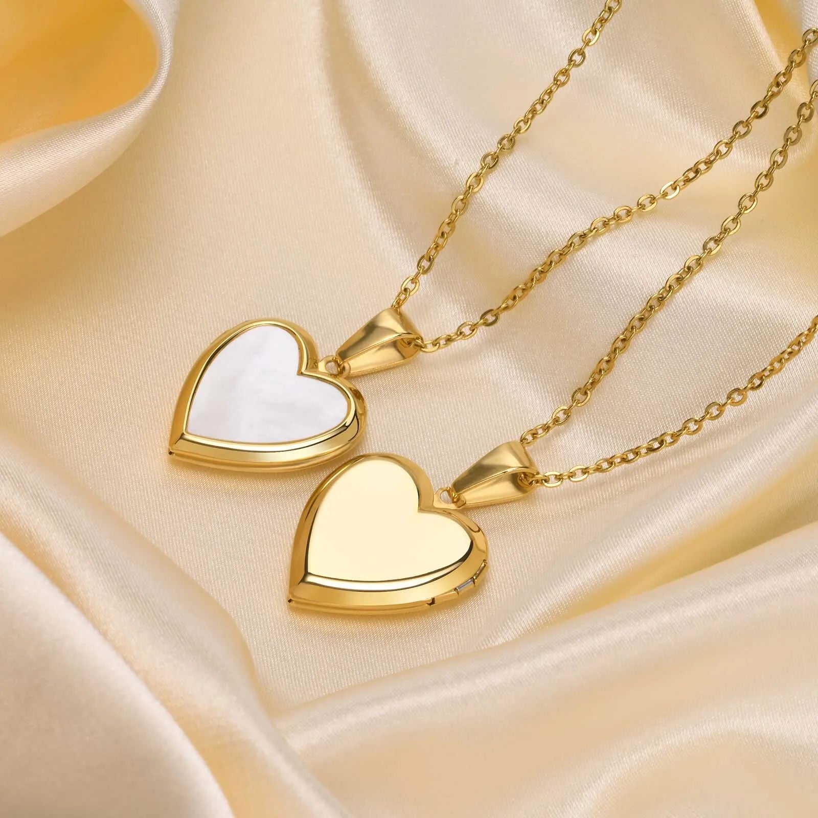 Heart-shaped gold pendants on a beige fabric background