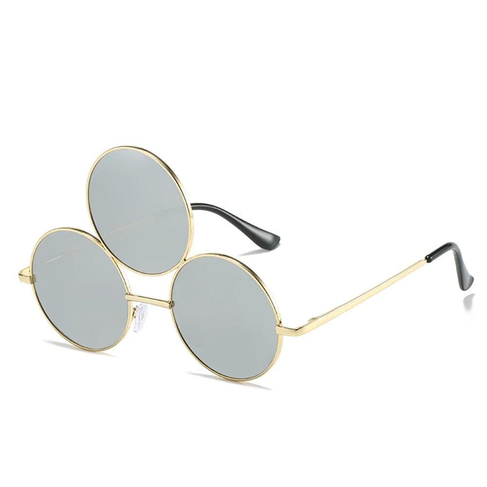 Sunglasses with gold frame and gray lenses on a white background