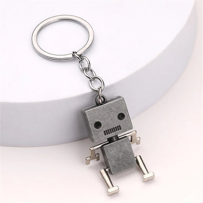 Silver metal robot keyring on white background