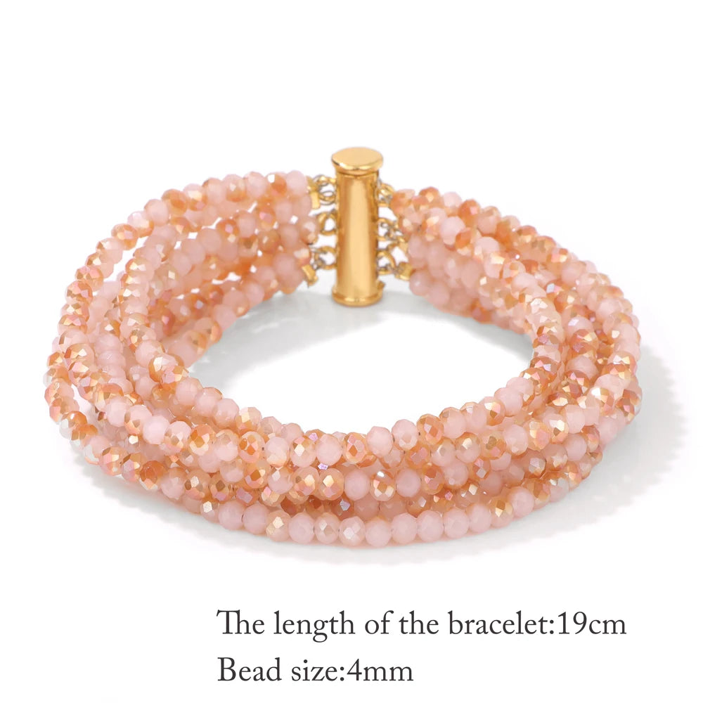 Multistrand beaded bracelet with gold clasp on a white background