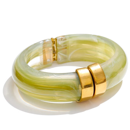 Yellow and white marbled bangle with gold accents on a white background