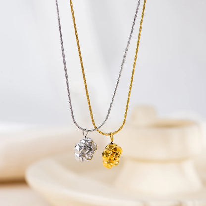 Two necklaces with rose-shaped pendants on a soft background