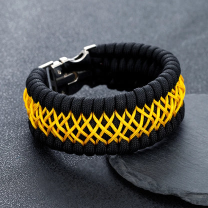 Black and yellow braided bracelet on a dark grey background