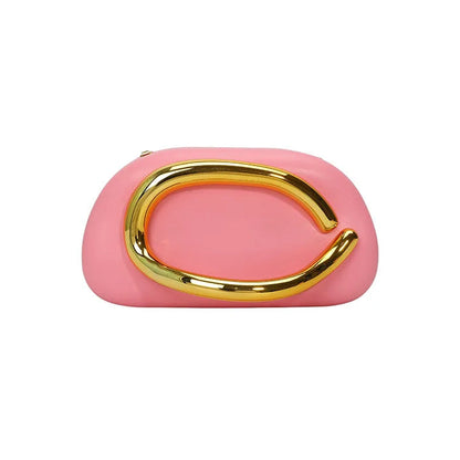 Pink clutch bag with a gold buckle handle on a white background