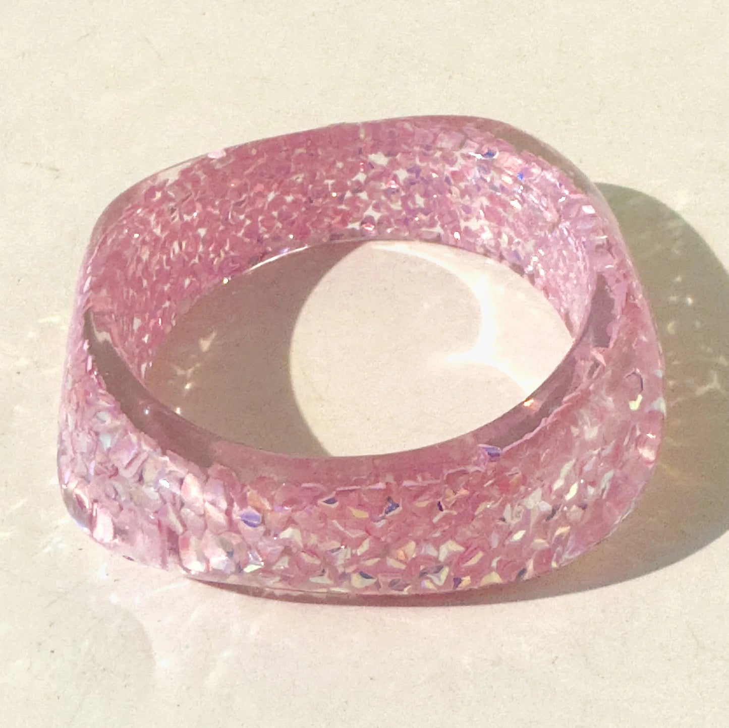 Pink glittery bangle on a light background