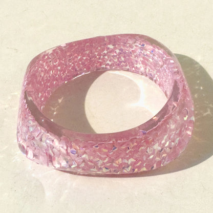 Pink glittery bangle on a light background