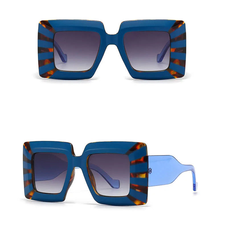 Blue and grey sunglasses with striped frame on a white background