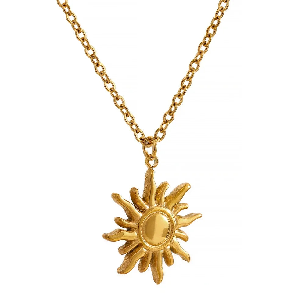 Gold sun-shaped pendant necklace on a white background