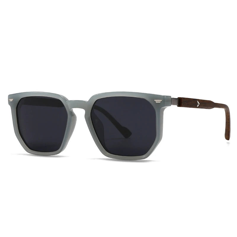 Sunglasses with grey frame and dark lenses on a white background