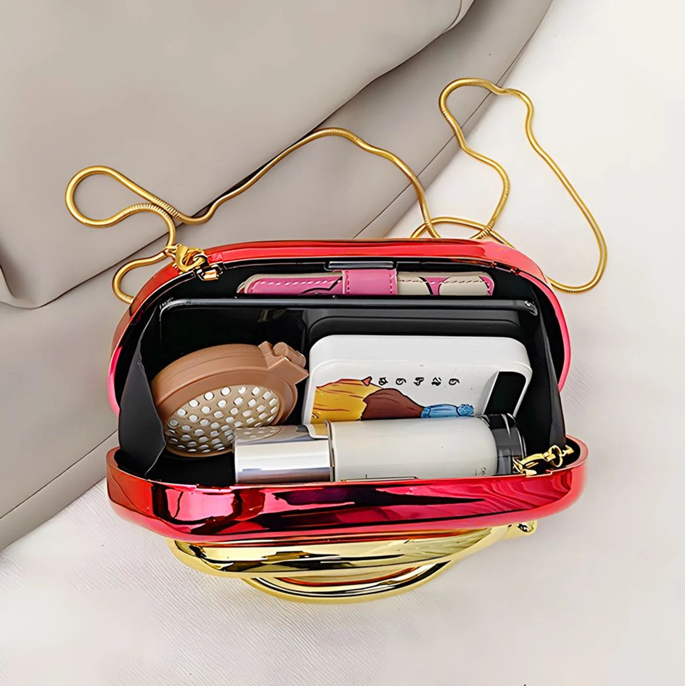 Clutch bag with cosmetic items including a brush and bottles on a light background