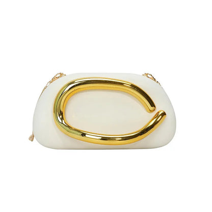 White clutch with gold handle on a white background