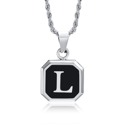 Silver necklace with a black pendant featuring the letter 'L' on a white background