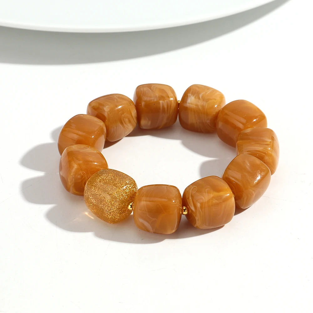 Orange beaded bracelet on a white background