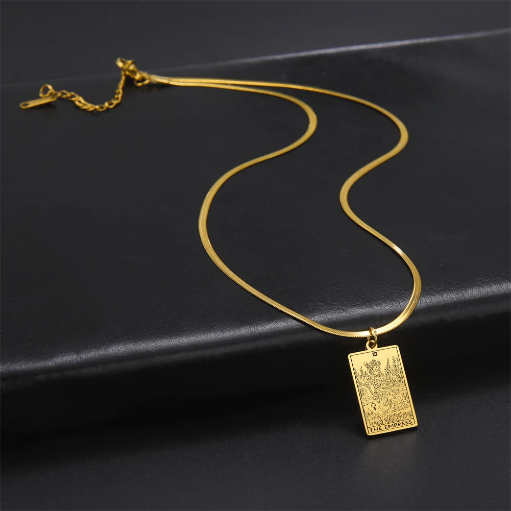 Gold necklace with a rectangular pendant on a black background