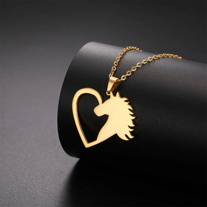 Gold necklace with a heart-shaped pendant featuring a horse design on a black background