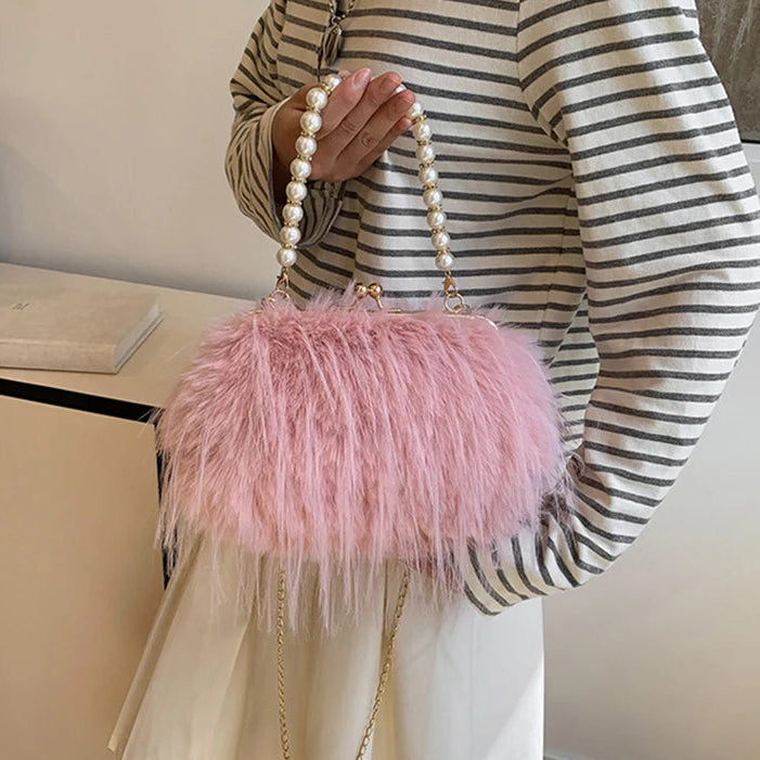 Person holding a pink fluffy handbag with pearl handle