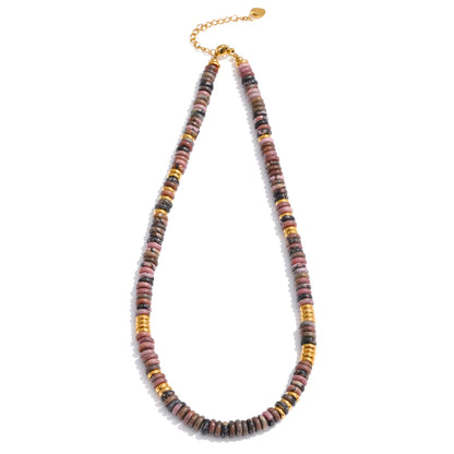 Necklace with multicoloured beads and gold accents on a white background