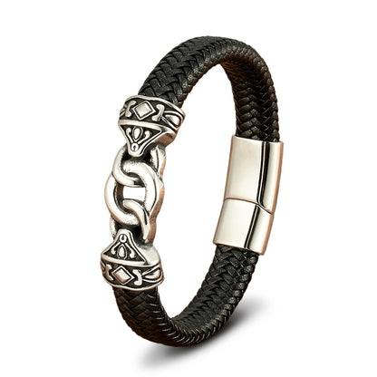 Black braided leather bracelet with silver Celtic knot design on a white background