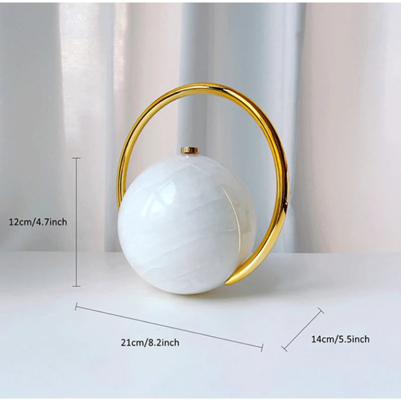Clutch bag with a white marbled sphere and gold circular frame shown with measurements on a light background