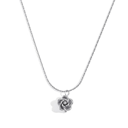 Silver rose-shaped pendant on a chain against a white background