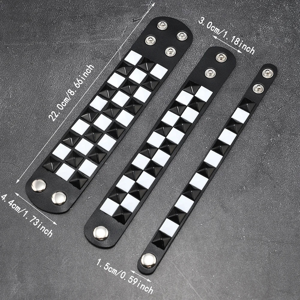 Three black leather bracelets with pyramid studs on a grey background with measurements.
