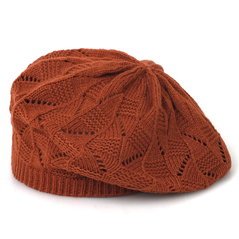 Brown knitted beret on a white background