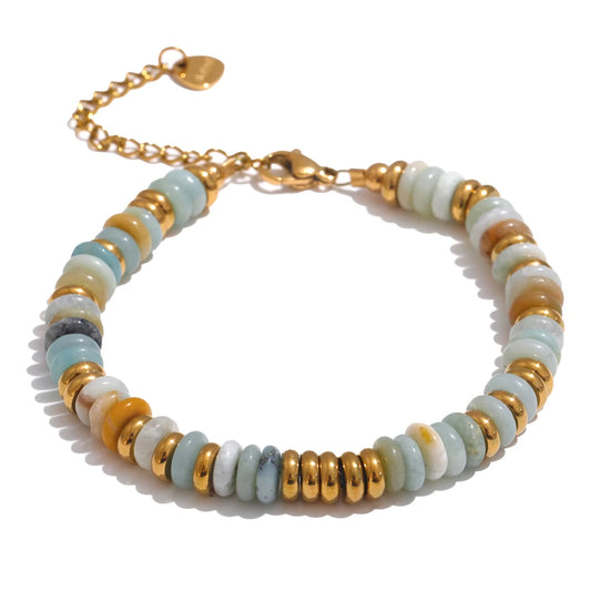 Bracelet with gold and multicoloured beads on a white background