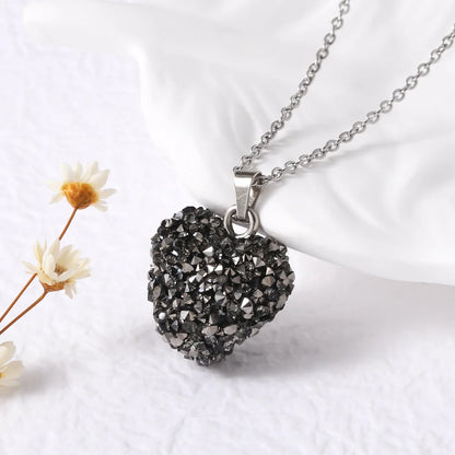 Necklace with a textured heart pendant on a white background with flowers.