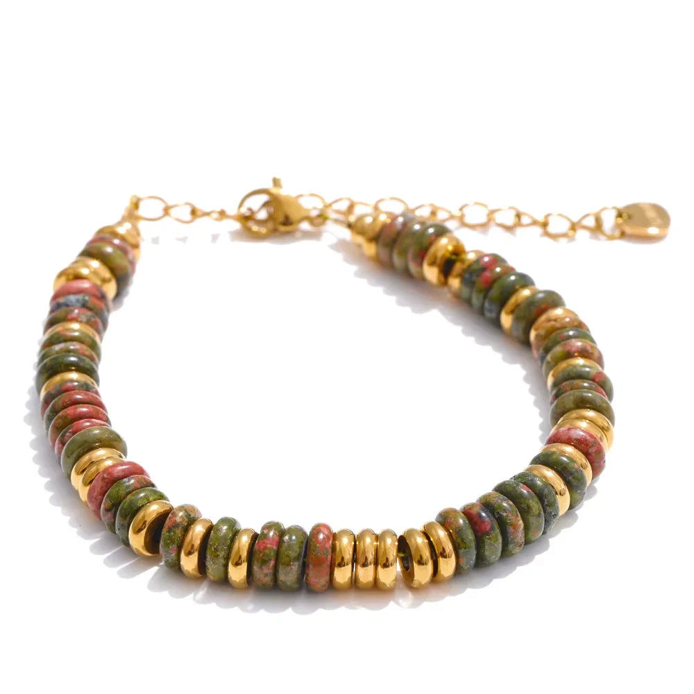 Multicoloured beaded bracelet with gold accents on a white background