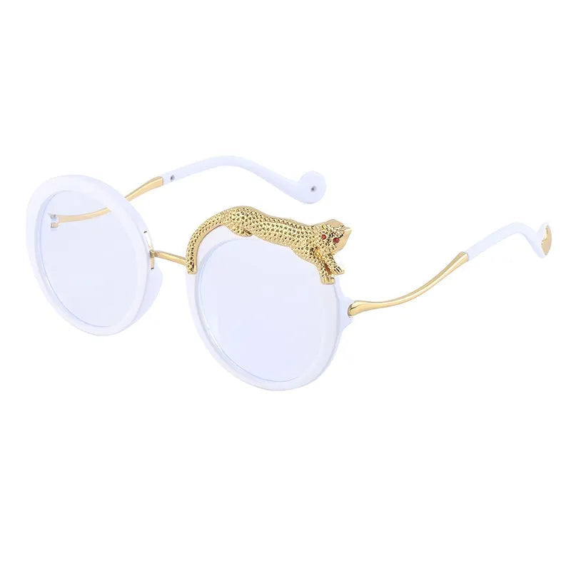 Sunglasses with gold accents and white lenses on a white background.