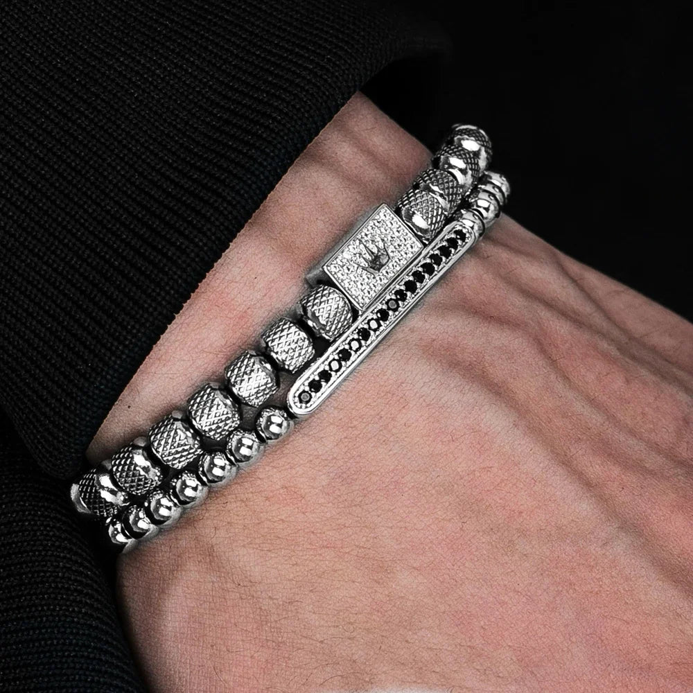Silver bracelet on a wrist with a dark background