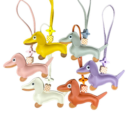 Set of colourful dachshund-shaped keychains on a white background