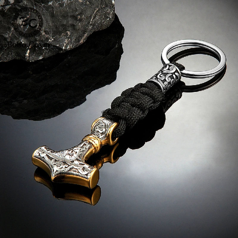 Keychain with Thor's hammer design on a reflective surface