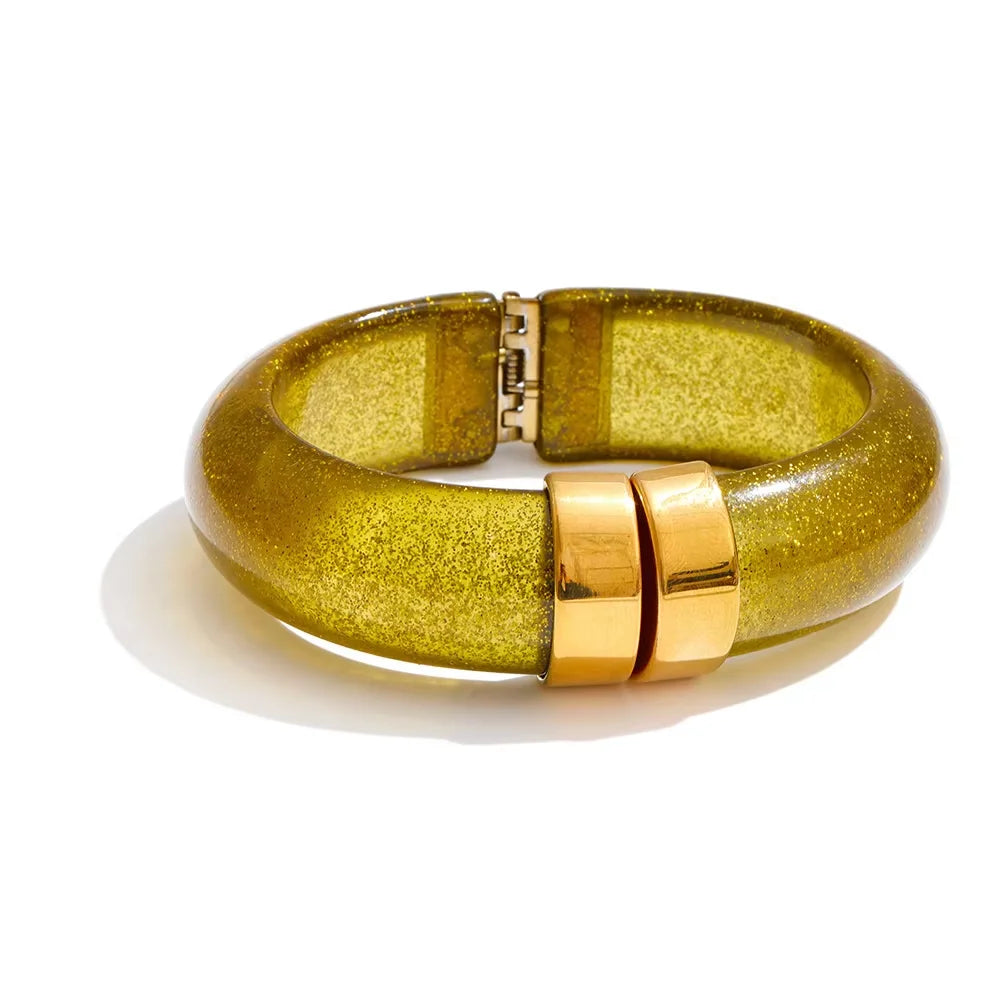 Gold bracelet with a glittery finish on a white background
