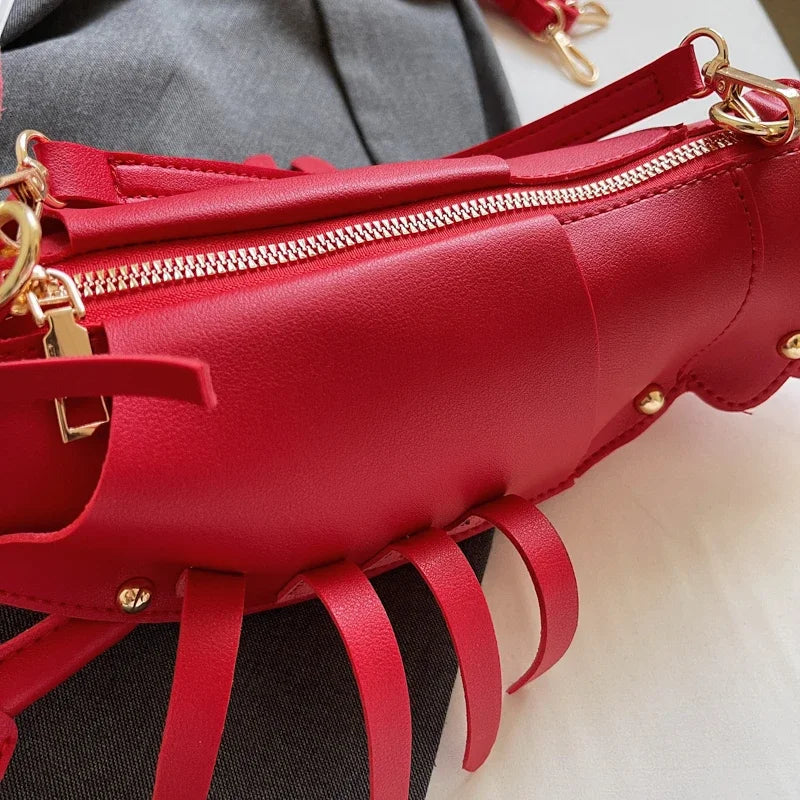 Red handbag with gold zippers and accents on a neutral background