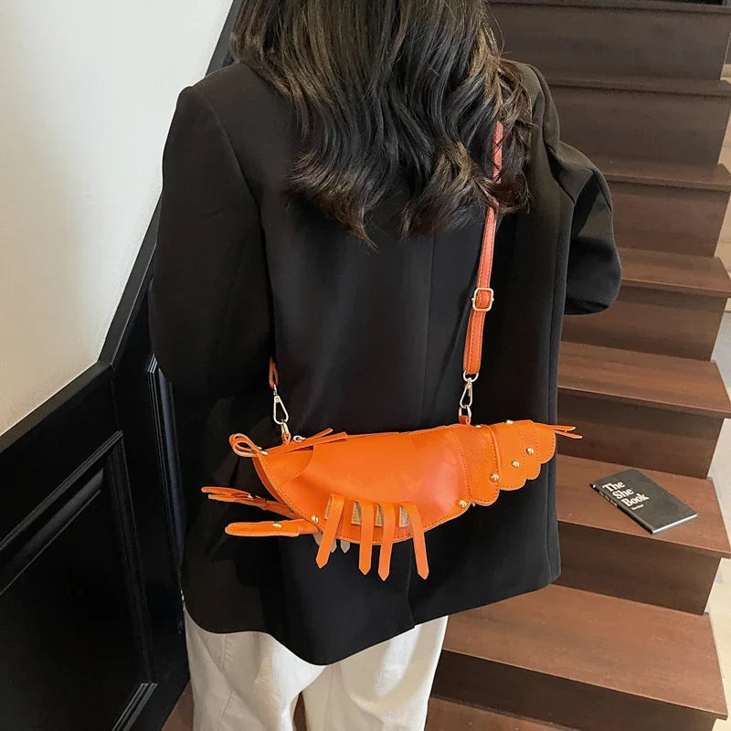Person wearing a black jacket with an orange lobster-shaped bag on a staircase.