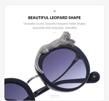 Sunglasses with a decorative leopard-shaped metal detail on a light grey background