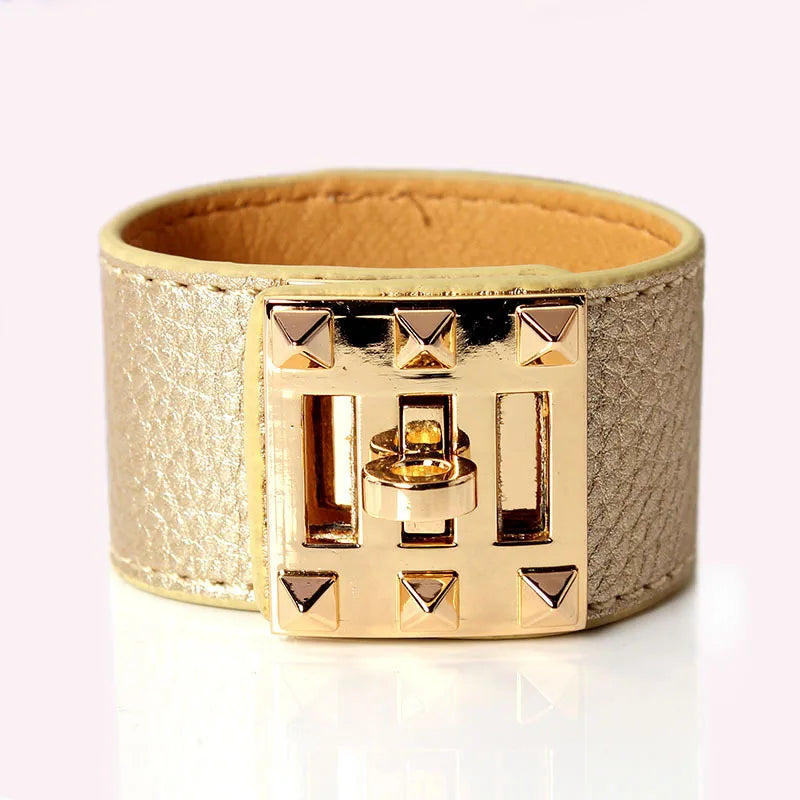 Gold bracelet with a geometric design on a white background