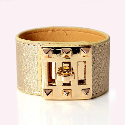 Gold bracelet with a geometric design on a white background