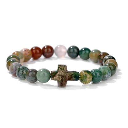 Multicoloured beaded bracelet with a cross charm on a white background