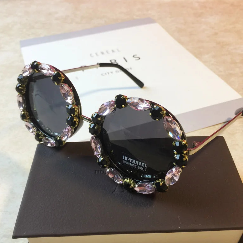 Decorative sunglasses with gemstones on a book